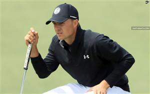 Jordan Spieth reads the line of the green